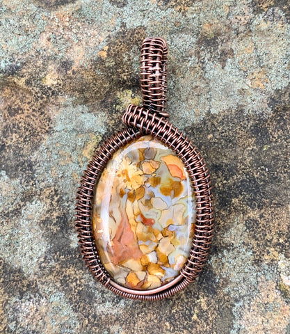 This colorful Conglomerate Stone Pendant with hues of blue, brown, orange and yellow has been wrapped in handwoven copper. An everyday go to that will match many outfits!