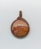 Beautiful colors of the sunset in this round Polychrome Jasper Pendant wrapped in copper.