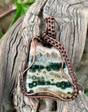 This wire wrapped pendant features a beautiful Ocean Jasper Slice with loads of druzy crystals. It has been kept raw around the sides for a more natural and organic feel.