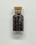 Glass Jar Filled with Tumbled Garnet Chips.  