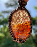 This one-of-a-kind pendant features a stunning Pink Plume Agate with a  druzy center, elegantly wrapped in handwoven copper. The copper’s warm tones enhance the pink and earthy hues of the agate, creating a captivating contrast that highlights the stone’s natural beauty and intricate patterns.