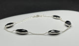 Delicate Adjustable Bracelet in Sterling Silver with Black Onyx Faceted Marquise Gemstones. 