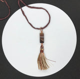 Elevate your style with the Brown Striped Column Agate Necklace, a beautifully designed piece that combines the natural elegance of striped agate with the luxurious feel of silk. This necklace features a stunning column of brown striped agate, complemented by a matching tassel, and is suspended on an adjustable silk cord, offering both versatility and sophistication.