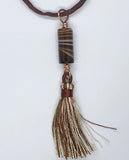 Elevate your style with the Brown Striped Column Agate Necklace, a beautifully designed piece that combines the natural elegance of striped agate with the luxurious feel of silk. This necklace features a stunning column of brown striped agate, complemented by a matching tassel, and is suspended on an adjustable silk cord, offering both versatility and sophistication.