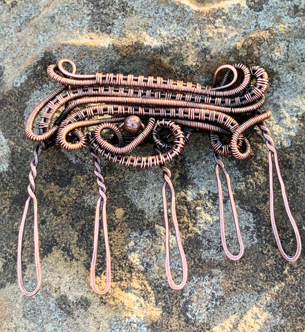 Layers of hand woven copper with a copper bead accent make this handmade hair comb stand out.