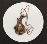 Bold size pendant features hand wrapped copper curves and swirls around a colorful agate.