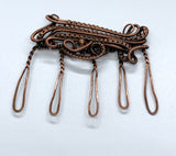 Layers of hand woven copper with a copper bead accent make this handmade hair comb stand out.