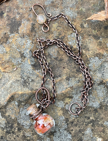 Glass Bottle Necklace in Wire Wrapped Copper, filled with Carnelian Chips. 