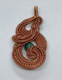 Layers of handwoven copper and copper coils surround a Lapis Chrysocolla Bead, creating a stunning intricate pendant.