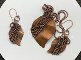 This stunning set features hand-cut, formed, and textured solid copper leaves, expertly wrapped with intricately woven copper. The pendant and matching earrings showcase the beauty of artisanal craftsmanship, capturing the organic elegance of nature. The rich, warm tones of the copper create a harmonious and versatile look, perfect for adding a touch of rustic charm to any outfit. This unique set makes a thoughtful gift for nature lovers or a beautiful addition to your own jewelry collection.