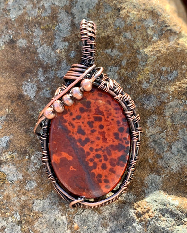 Colorful Poppy Jasper Pendant with brilliant red colors wrapped in copper with copper bead accents.