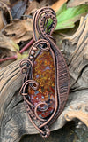 Colorful Red and Yellow Agate Pendant in layers of wire wrapped, curled and coiled copper.