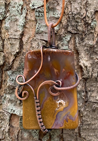 Beautiful Polished Agate necklace with hammered and wire wrapped Copper on an adjustable leather cord.