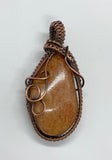 Tumbled River Rock Pendant wrapped in Copper.