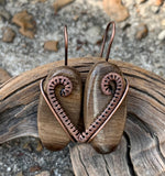 These elegant earrings feature rich brown Petrified Wood, showcasing the natural beauty and unique grain patterns of fossilized wood. Wrapped in intricately handwoven copper, the warm tones of the copper complement the earthy hues of the Petrified Wood, creating a timeless and organic design.