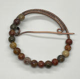 Multi-colored Red Creek Jasper surrounds this handmade wire wrapped Copper Pin. 
