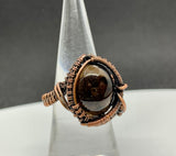 Wire wrapped Copper adjustable ring with a Smoky Quartz Cabochon Center.