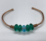 Add some Color and Bling with this Heavy Gauge Copper Bracelet - melted at the ends - with green and blue Glass Rondelle Beads. 