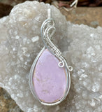 This elegant pendant features a captivating lilac Phosphosiderite gemstone, set in sleek sterling silver for a refined and timeless look. The soft lavender hues of the stone exude tranquility and sophistication, making it a perfect statement piece. Handcrafted with care, this pendant is ideal for those who appreciate unique gemstones and graceful, artisan jewelry.