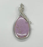 This elegant pendant features a captivating lilac Phosphosiderite gemstone, set in sleek sterling silver for a refined and timeless look. The soft lavender hues of the stone exude tranquility and sophistication, making it a perfect statement piece. Handcrafted with care, this pendant is ideal for those who appreciate unique gemstones and graceful, artisan jewelry.