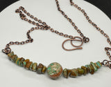 Copper Necklace with Sea Sediment Jasper in the middle surrounded by Kingman Turquoise chips. 