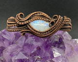 Multiply layers of hand woven and coiled copper in softly swaying lines capture this beautiful Rainbow Moonstone in this adjustable bracelet. 