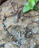 Copper Chain Eyeglass Holder Necklace with 5 Rainbow Kissed Spanish Moss Crystals on each side. Comes with adjustable rubber ends connectors. 