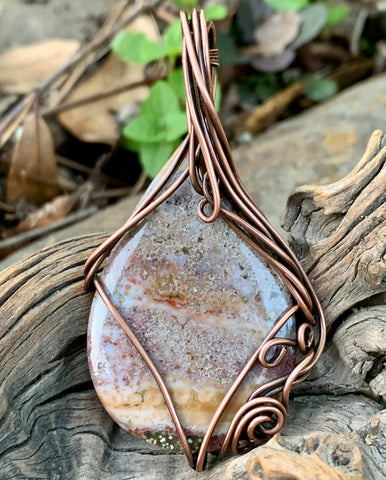 Copper Swirls Surround this Ocean Jasper Cabochon creating a unique and interesting pendant.