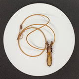 Petrified Palm Wood Necklace wrapped in Copper with Glass Bead Accent and Leather Cord. 