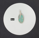 A beautiful Quartz pendant with silicated Chrysocolla inclusions and Turquoise accent beads in wire wrapped Sterling (.925) and Fine (.999) Silver.