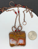 Polished Moroccan Seam Agate Slice Necklace wrapped in handwoven copper with Swarovski crystal accents and a copper chain with glass beads. 