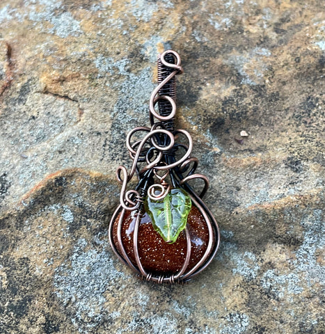 Swirling Goldstone Pumpkin Pendant in Copper with Glass Leaf Accent. Perfect for Fall!