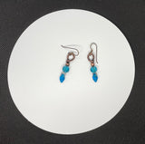 These dazzling earrings feature sparkling blue glass leaves, beautifully paired with shimmering blue crystals for an eye-catching look. Finished with hypoallergenic niobium ear wires, these earrings are both stylish and comfortable. Perfect for adding a pop of color and a hint of nature-inspired beauty to any outfit.