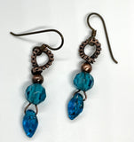 These dazzling earrings feature sparkling blue glass leaves, beautifully paired with shimmering blue crystals for an eye-catching look. Finished with hypoallergenic niobium ear wires, these earrings are both stylish and comfortable. Perfect for adding a pop of color and a hint of nature-inspired beauty to any outfit.