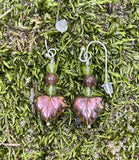 These Sterling Silver (.925) Earrings with Glass Leaves, Peridot, and Purple Aventurine are a delicate and colorful pair of earrings that combine the elegance of sterling silver with the vibrant beauty of peridot and purple aventurine. Accented with intricate glass leaves, these earrings offer a unique blend of nature-inspired elements and gemstone sophistication.
