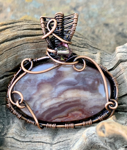 Beautiful Swirling Purple Coprolite Pendant (fossilized dinosaur poo) wrapped in handwoven copper with swarovski crystal accent bead.