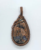 Colorful Que Sera Stone Pendant with pink, peach and blue wrapped in wire wrapped copper. 