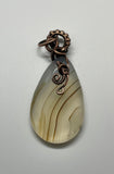Lovely Translucent Striped Agate Pendant in Wire Wrapped Copper. 