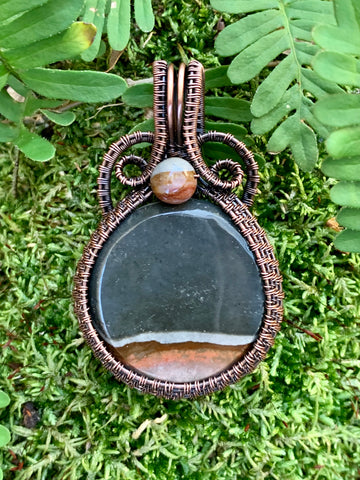 Scenic round Polychrome Jasper Pendant wrapped in hand woven copper with a matching Polychrome Jasper bead accent.