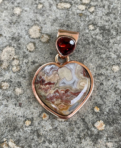 Colorful Laguna Lace Agate Heart Pendant in Copper with Garnet Gemstone in the Bail.