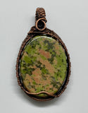 Multi-colored green and pink Unakite Pendant in Wire wrapped copper. Unakite is a true rock: a composite material made up of multiple other stones - this gives unakite its familiar moss-on-brick appearance.