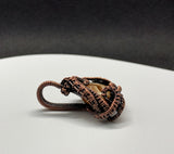 Striking Brown Striped Rhodochrosite Pendant wrapped in hand woven copper.