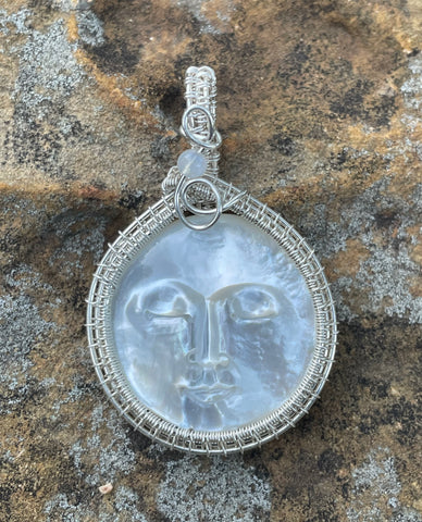 Carved Mother of Pearl Face Pendant in Wire Wrapped Argentium Silver with Rainbow Moonstone Accent.