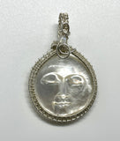 Carved Mother of Pearl Face Pendant in Wire Wrapped Argentium Silver with Rainbow Moonstone Accent.