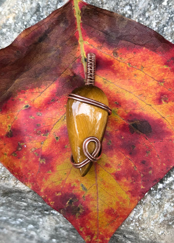 This small tiger eye teardrop pendant is hand wrapped in copper, polished and sealed.