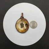 This Cool Reversible Agate Pendant has a center of Marcasite and is wrapped in handwoven Copper. 