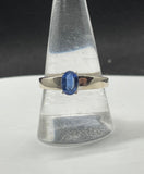 This exquisite ring showcases a faceted Blue Kyanite gemstone, known for its captivating deep blue hues and natural shimmer. Set in a sleek Sterling Silver band, the design highlights the stone's brilliance while offering a timeless elegance. Perfect as a statement piece or for everyday wear, this ring is a must-have for any jewelry enthusiast.