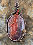 Colorful Agate Pendant in Wire Wrapped Copper with Carnelian Bead Accents. A vibrant one of a kind piece. 