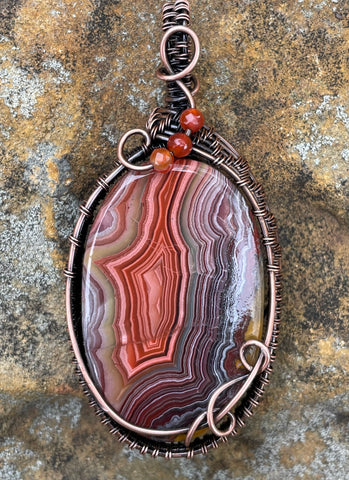 Colorful Agate Pendant in Wire Wrapped Copper with Carnelian Bead Accents. A vibrant one of a kind piece. 
