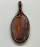 Colorful Agate Pendant in Wire Wrapped Copper with Carnelian Bead Accents. A vibrant one of a kind piece. 